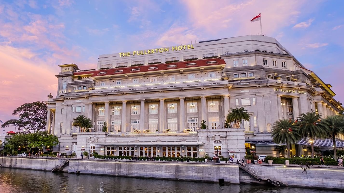 Exterior view of The Fullerton Hotel Singapore with bridge over Singapore River
